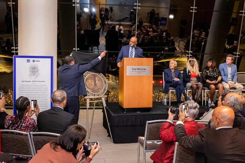 Phil Washington unveils the Hall of Equity medallion honoring aviation pioneers Bessie Coleman and Ed Dwight during the Center for Equity and Excellence in Aviation dedication event at Denver International Airport.