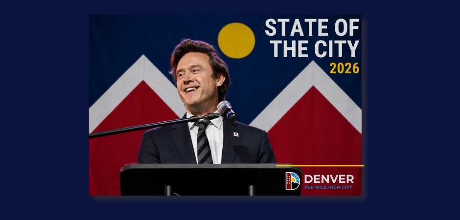 Denver Mayor Mike Johnston smiles while delivering the 2026 State of the City address from a podium, with the Denver city flag displayed behind him and the words "2026 State of the City" featured prominently on the graphic.