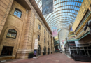 The Denver Performing Arts Complex’s covered Galleria walkway, with the Ellie Caulkins Opera House and Garner Galleria Theatre visible beneath the glass canopy.