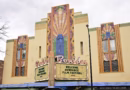 Art Deco façade of the Boulder Theater beneath an overcast sky, with its marquee reading, “Welcome Sundance Film Festival 2027.”