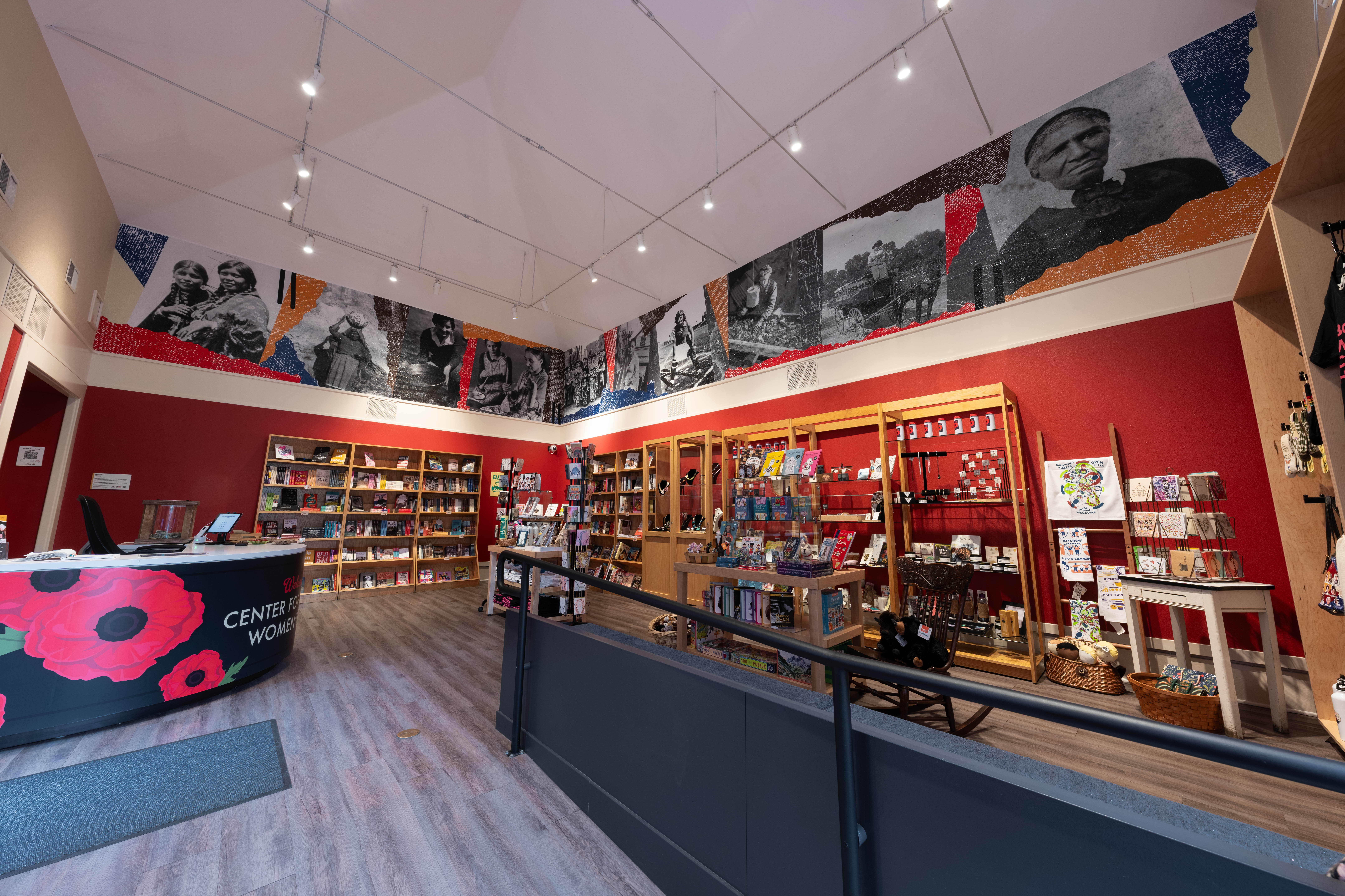 The Shared History mural stretches across the upper walls of the Center for Colorado Women’s History, displaying historic photographs of women above the museum’s shop and exhibits.