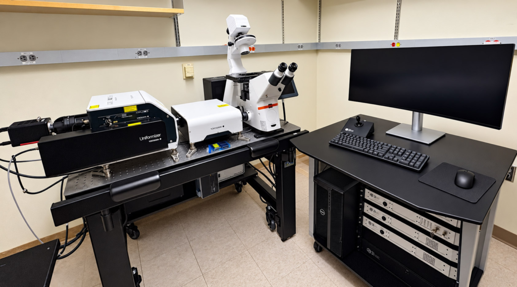 Advanced 3i microscopy system with imaging equipment, computer controls and monitor inside a laboratory.