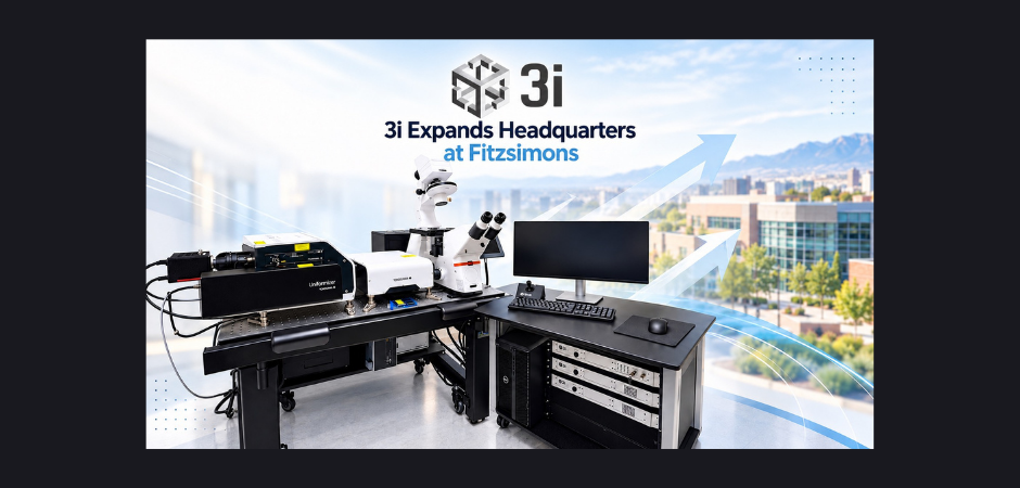 Featured graphic announcing 3i’s headquarters expansion at Fitzsimons, showing an advanced microscopy system and computer workstation with a blurred research campus and mountain backdrop.