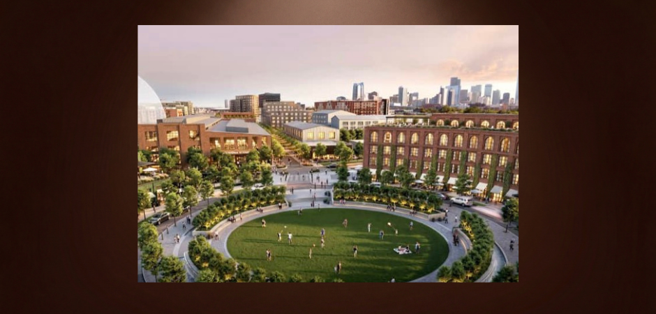 Architectural rendering of a proposed mixed-use development near Denver’s Burnham Yard, featuring a landscaped public park, pedestrian walkways, residential buildings and the downtown Denver skyline.