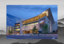 Exterior of the History Colorado Center in downtown Denver at dusk, featuring modern architecture, illuminated windows and a distinctive angular roofline.