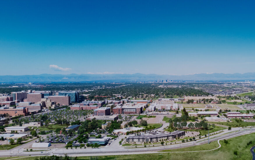 Aerial view of Fitzsimons Innovation Community and the surrounding Anschutz Medical Campus in Aurora, Colorado, with the Rocky Mountains in the distance.